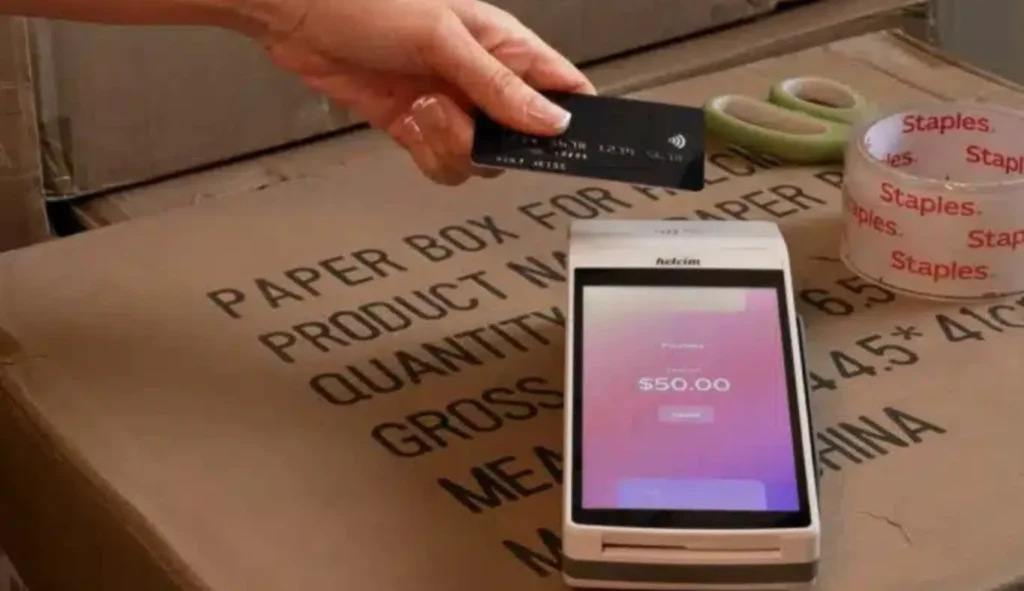 Hand tapping a black credit card on a POS terminal for adult industry payment processing