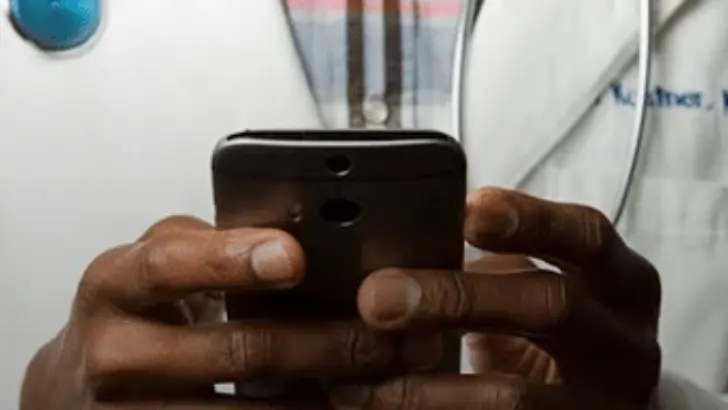 Telehealth provider using a smartphone during a patient consultation