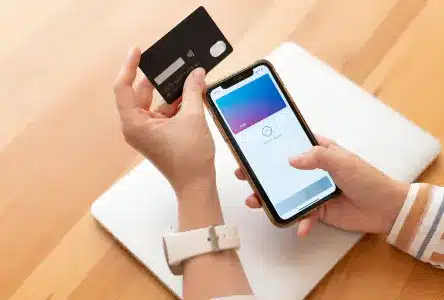 Collector paying online on a smartphone for a high-value graded trading card