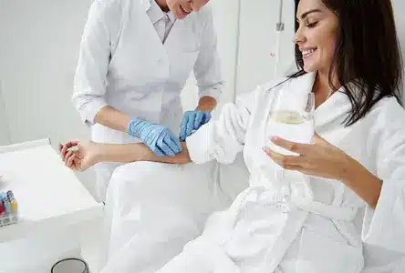 Client relaxing during an IV therapy session included in a multi-session wellness package