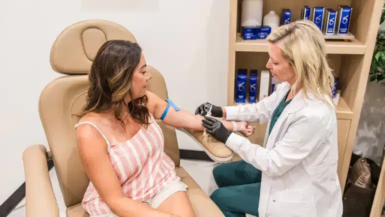 Provider checking a patient’s blood pressure at a medical weight loss clinic that offers recurring program payments
