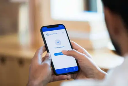 Client paying an appointment deposit on a smartphone to book a future wellness treatment